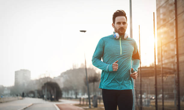 istock Handsome runner exercising by running and jogging  in city 661871604