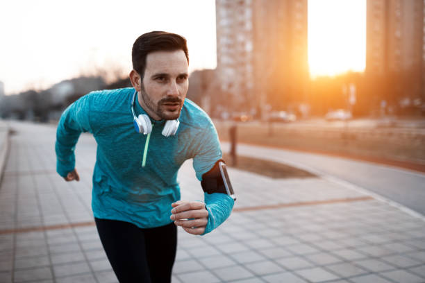 istock Handsome runner exercising by running and jogging  in city 661872104