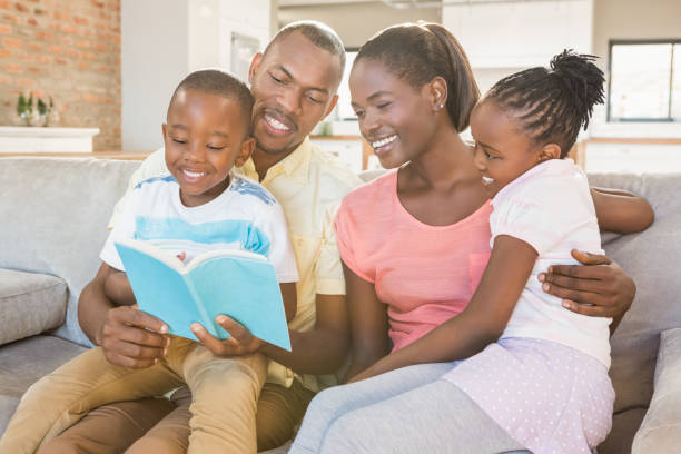 istock Happy family reading a book together 661879328