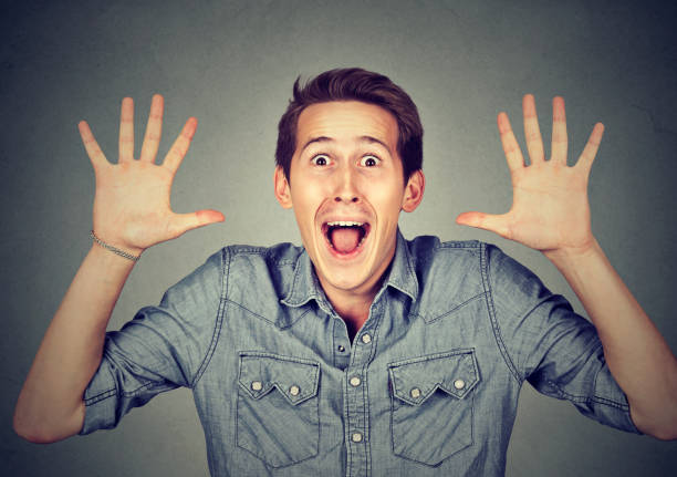 istock Happy young man going crazy screaming super excited surprised 661885344