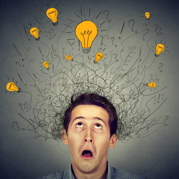 istock Surprised man with many ideas light bulbs above head looking up 661885696