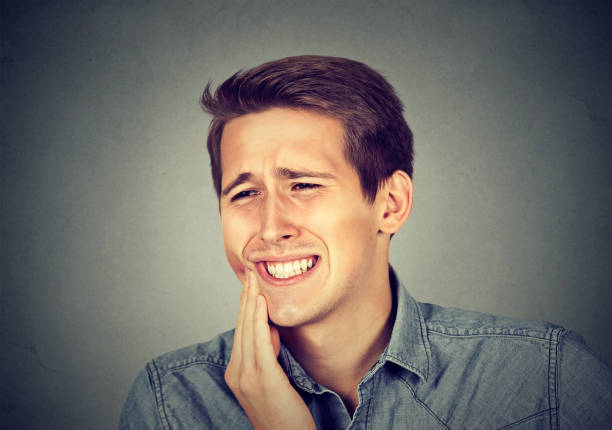 istock Closeup portrait young man with sensitive toothache 661886342