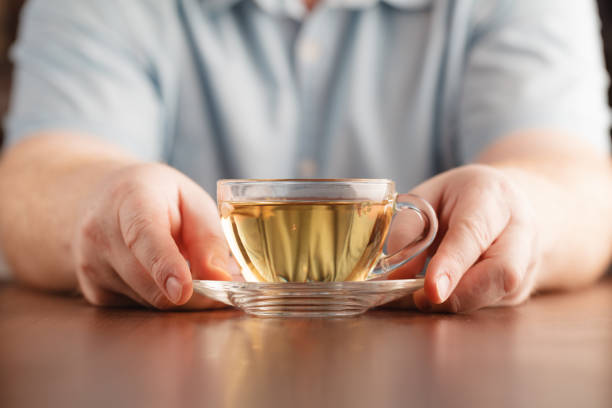 istock Man hold cup in hand and offer tea 661886346