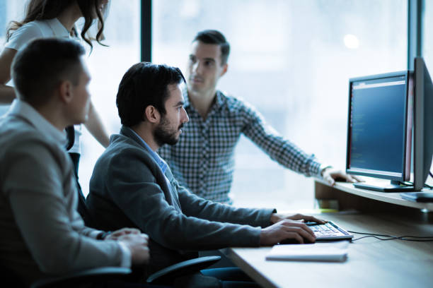 istock Coworkers working on project together in company office 661887676