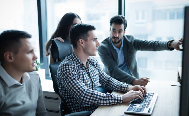 istock Group of business people and software developers working as a team in office 661888000