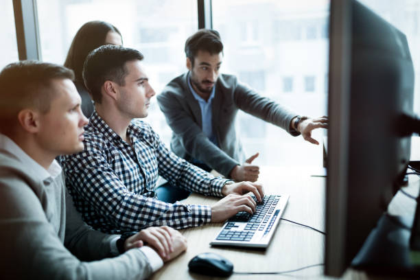 istock Coworkers working on project together in company office 661888054