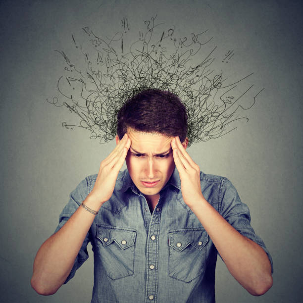 istock Stressed man with a headache isolated on gray wall background 661895772