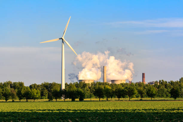 Electricity by wind power versus coal power stock photo