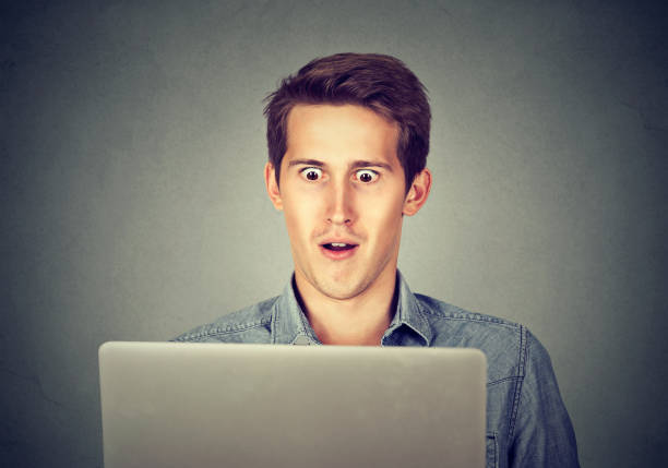 istock Shocked man looking at laptop 661896870