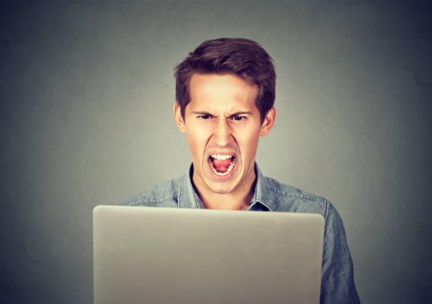 istock Angry furious business man screaming at computer 661896888