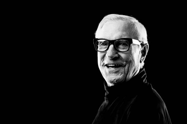 Black and white portrait of cheerful senior man in eyeglasses