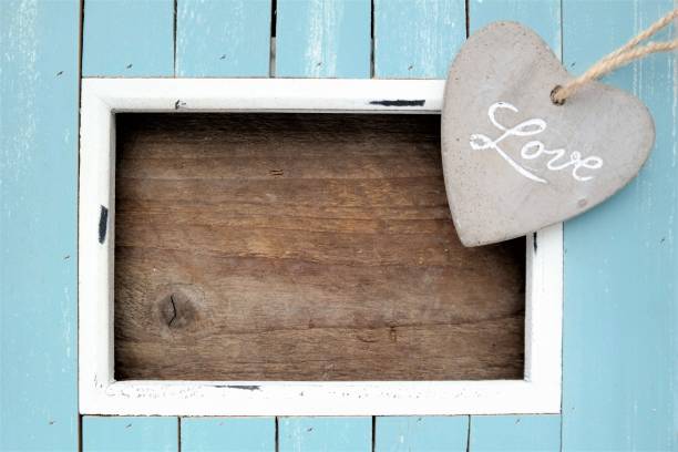 istock wooden frame with a stone heart and text space 661905462