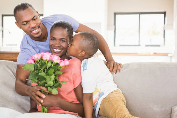 son surprising mother with flowers - men african descent giving flower imagens e fotografias de stock