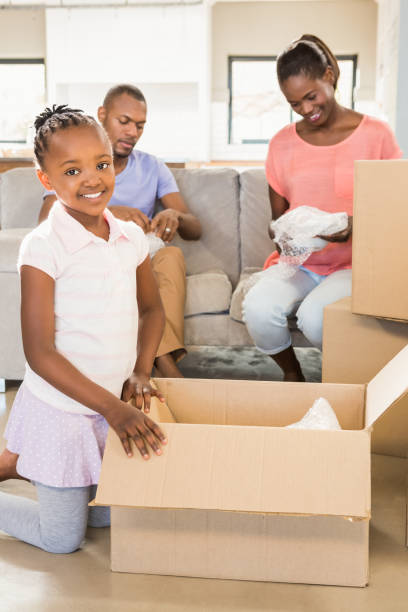 istock Family unwrapping things in new home 661913598
