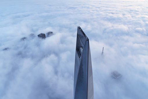 Aerial view of Shanghai World Financial Center and skyscraper in the thick fog at sunrise, China.