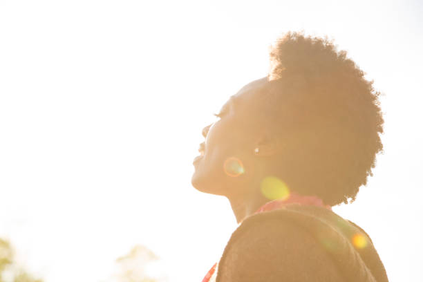 istock Woman enjoys feeling the sun on her face. 661953172