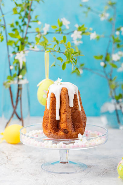 istock Traditional Easter cake with colored eggs and flowers. Blue background 661977750