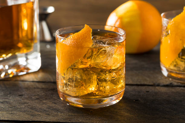 Boozy Homemade Old Fashioned Bourbon on the Rocks Boozy Homemade Old Fashioned Bourbon on the Rocks with an Orange Garnish bourbon whiskey photos stock pictures, royalty-free photos & images