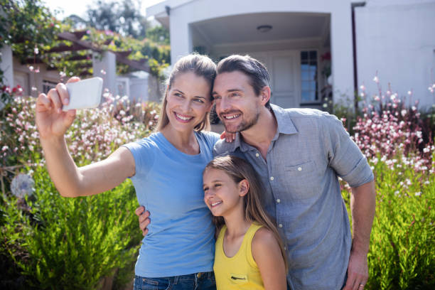 istock Parents and daughter taking a selfie on mobile phone 661989712