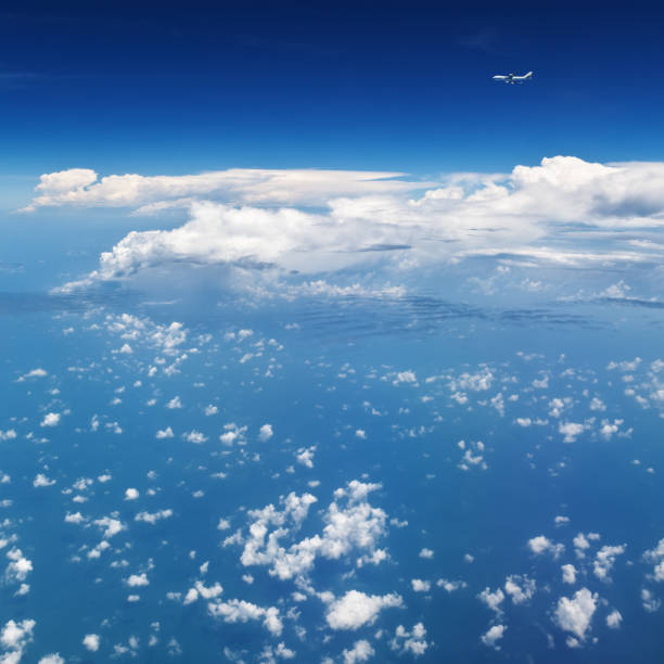 airplane flying in mid air above clouds. clear sky background - cloud mid air cloudscape aerial view imagens e fotografias de stock