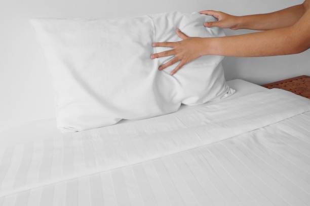 istock set up white pillow on bed sheet in hotel room 662014954