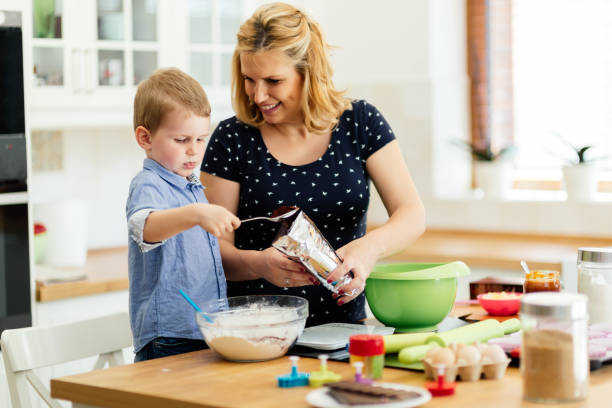 istock Happy mother and child in kitchen preparing cookies 662033068