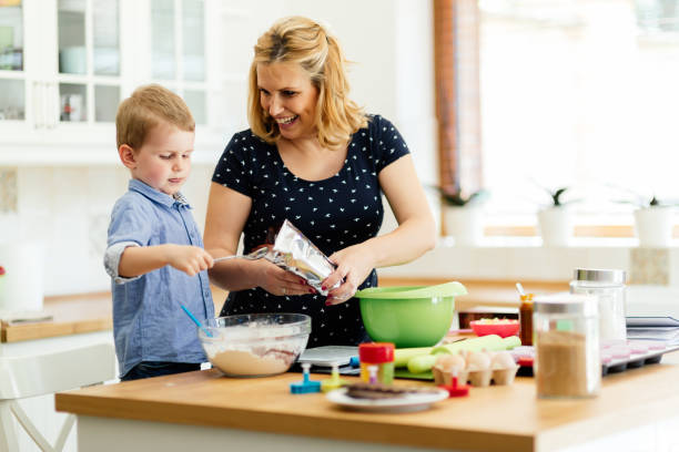 istock Mother and child preparing cookies in kitchen 662033118
