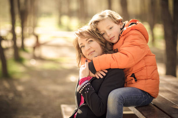 istock Happy mother and son in green park 662042638