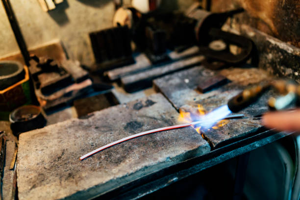 istock Jeweler processing metal bar by heating it up 662048770