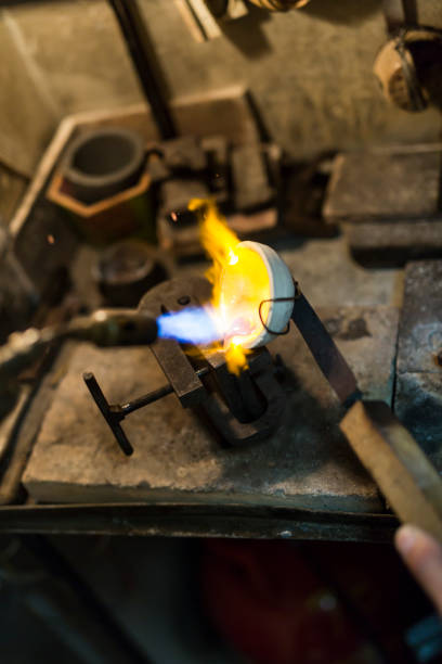 istock Goldsmith melting metal to liquid state 662050374
