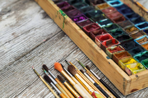 istock Box with watercolors and brushes on a wooden surface 662050572