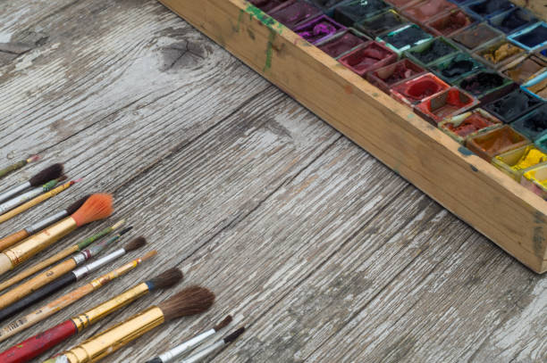 istock Box with watercolors and brushes on a wooden surface 662050574