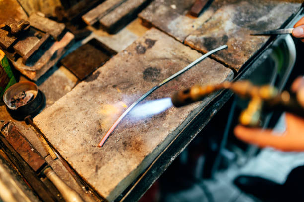 istock Jeweler processing metal bar by heating it up 662050942