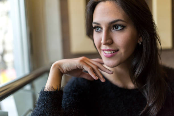 istock Pensive beautiful brunette looking out the window 662059244
