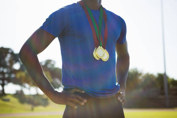 istock Mid section of athlete posing with gold medal after victory 662064662