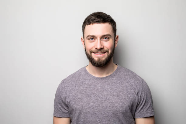 istock portrait of happy man on grey 662077318