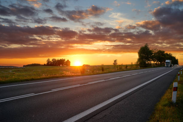 istock Sunset over the road, truck arriving from afar. 662079686
