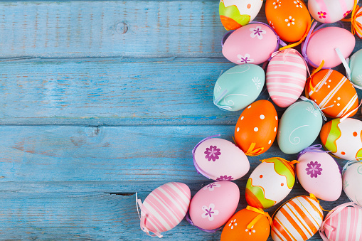 Colorful easter eggs on turquoise rustic wooden table