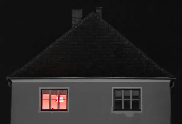 House with red light shining threw window