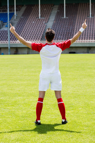 istock Excited football player standing in stadium 662092162