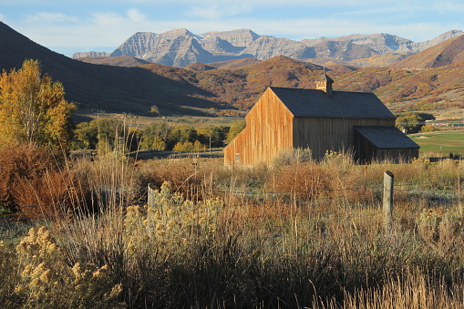 Historic Tate Barn in the fall with Mount Timpanogas in the background, Midway, Utah