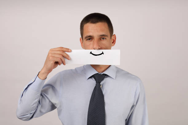 istock Disgruntled, unsatisfied employee with artificial smile 662124156