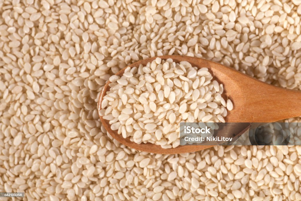 Background of fresh sesame seeds in wooden spoon Background of fresh sesame seeds in a wooden spoon Agriculture Stock Photo