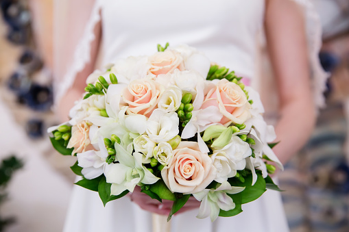 Beautiful wedding bouquet of flowers in bride’s hands