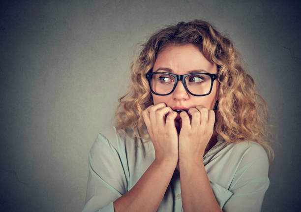 istock Closeup portrait nervous stressed young woman biting fingernails 662227876