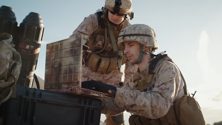 Soldiers are Using Laptop Computer for Surveillance During Military Operation in the Desert. Slow Motion.