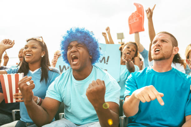 istock Crowd of fans cheering from stadium bleachers 662230078