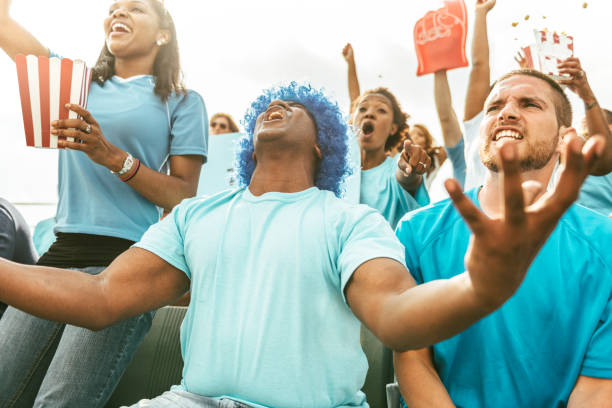 istock Crowd of fans cheering from stadium bleachers 662241310