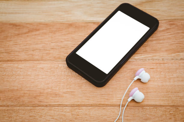 istock Black smartphone with white headphones 662252944