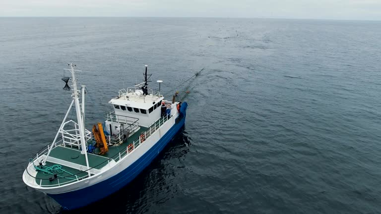 Flying over a Commercial Fishing Ship that Pulls Trawl Net